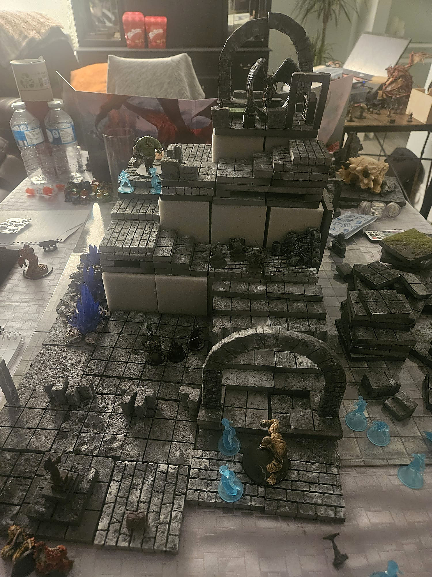 A multi-level stone tower with glowing blue spirits and adventurers