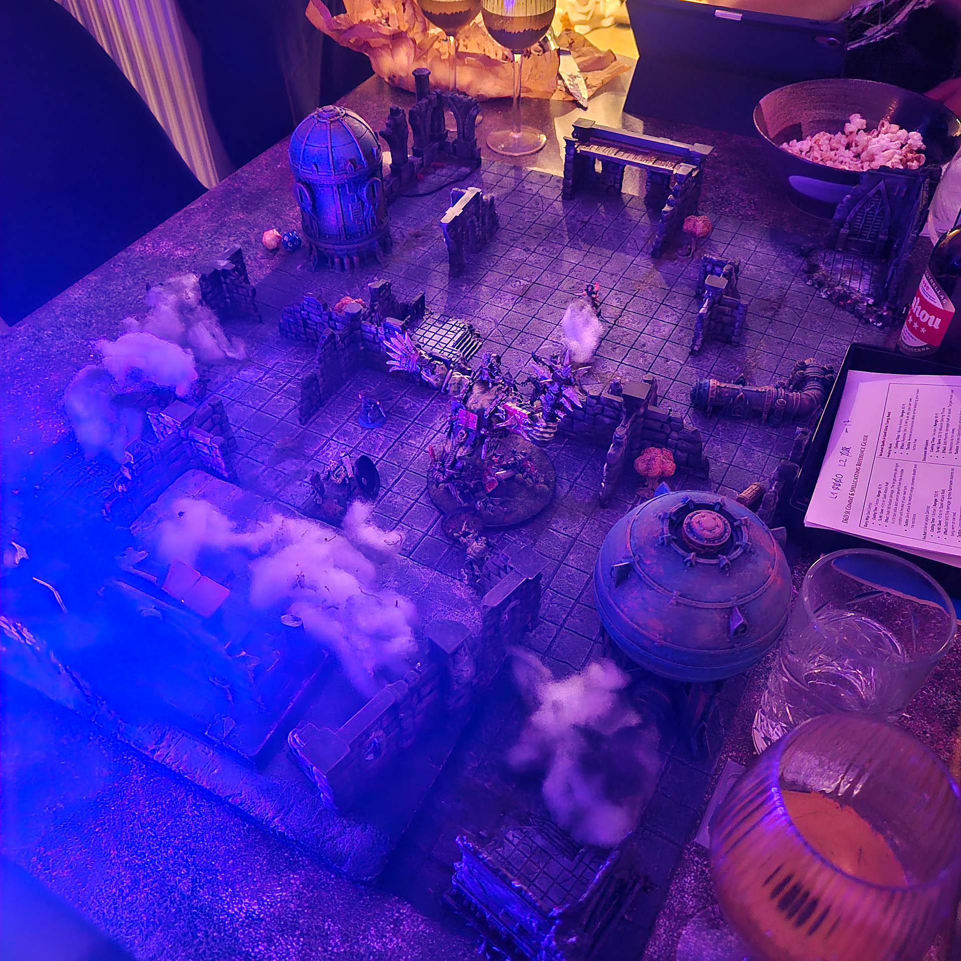 A blue-lit dungeon board with cotton smoke drifting between the walls