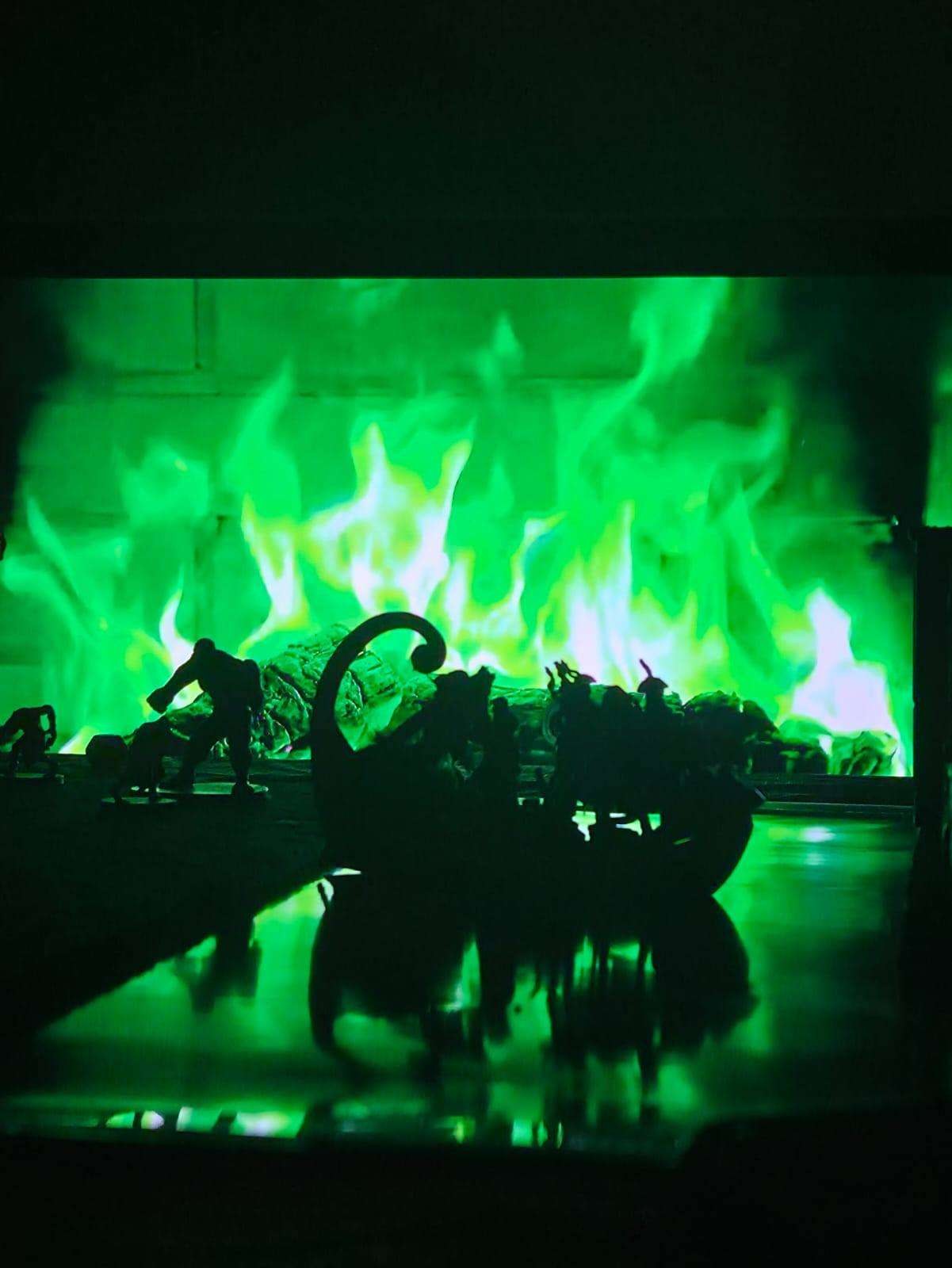 A green dragon looming over the battle mat