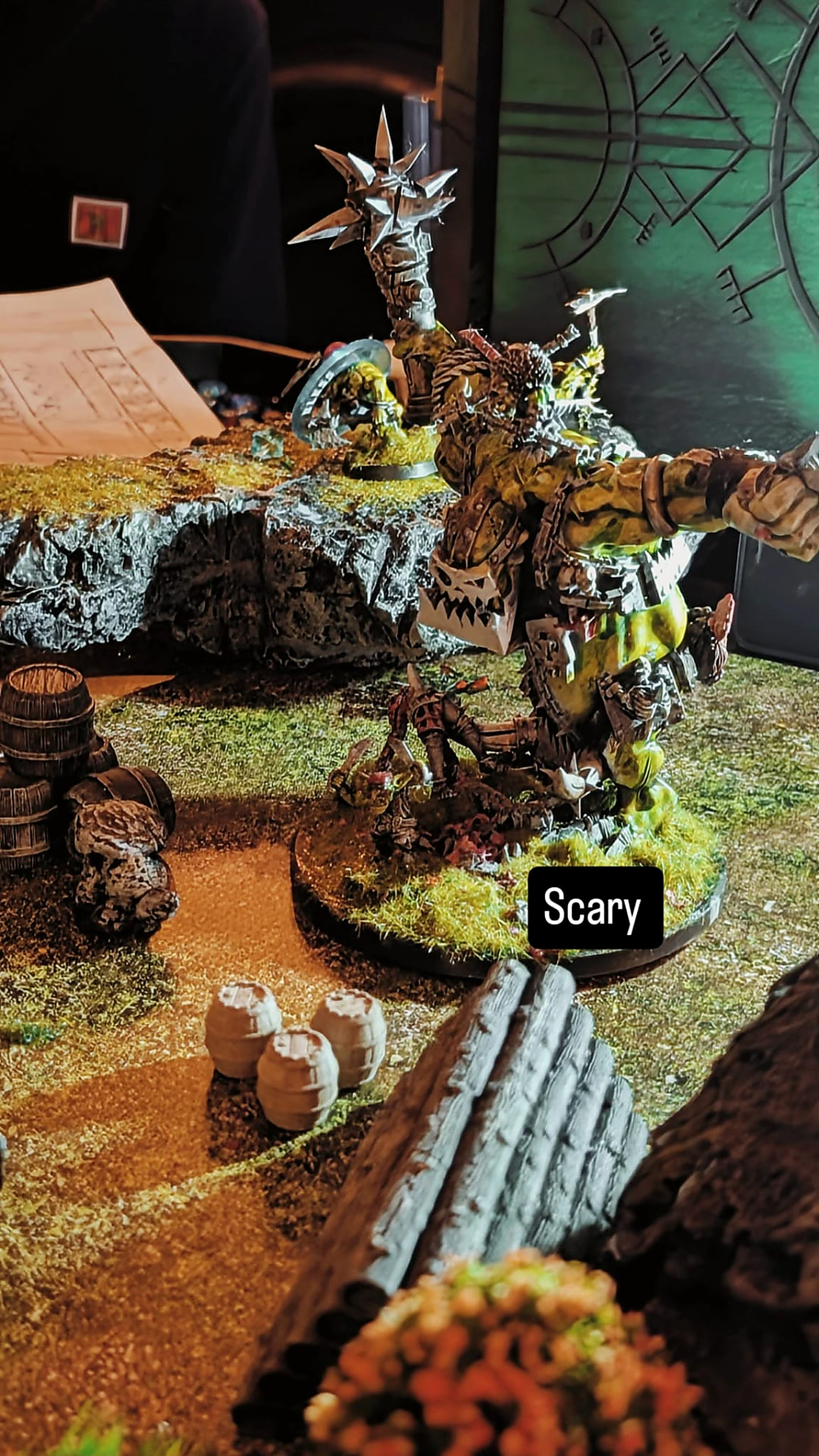A huge orc warboss miniature towering over the battlefield
